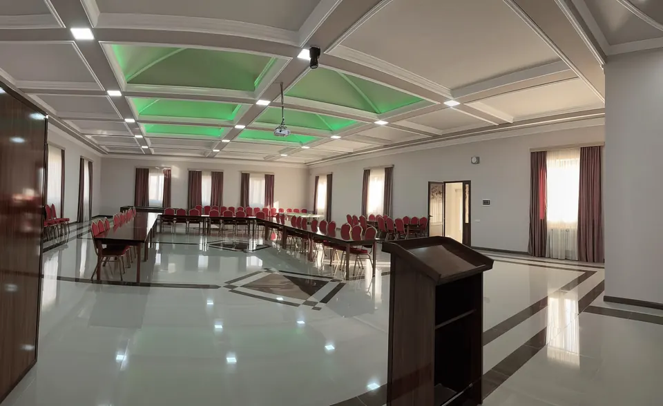 Conference hall with a lectern and green ceiling lights