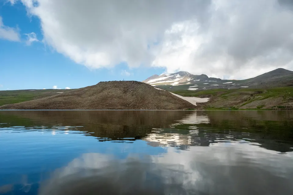 Mount Aragats reflected in the still water of Lake Kari