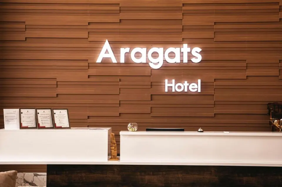 Reception desk with wood-panelled wall